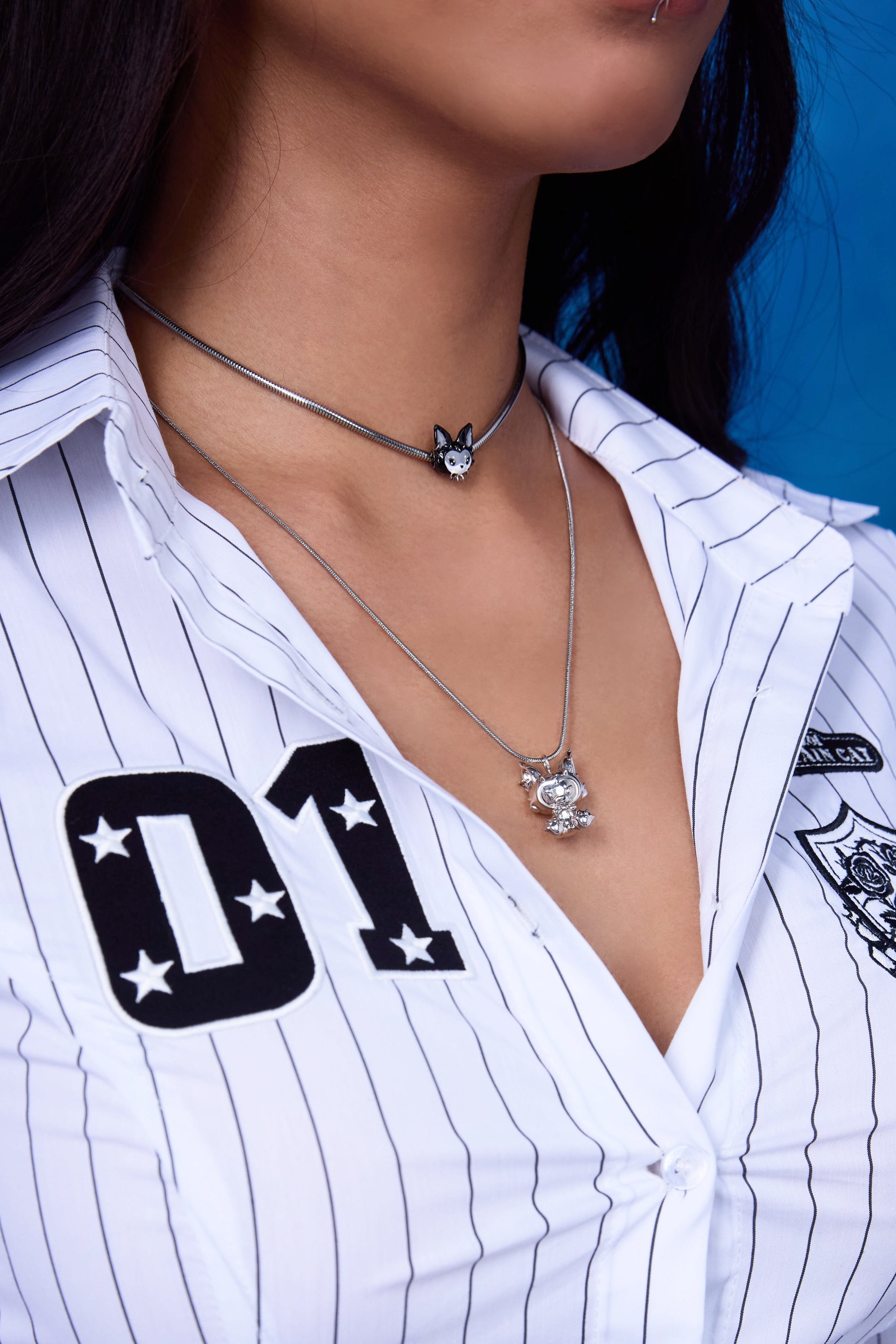FEFE Dog Drop Necklace and FEFE Dog Choker layered look — silver snake chain with dog figure pendant layered with dog charm choker, styled with white pinstripe shirt