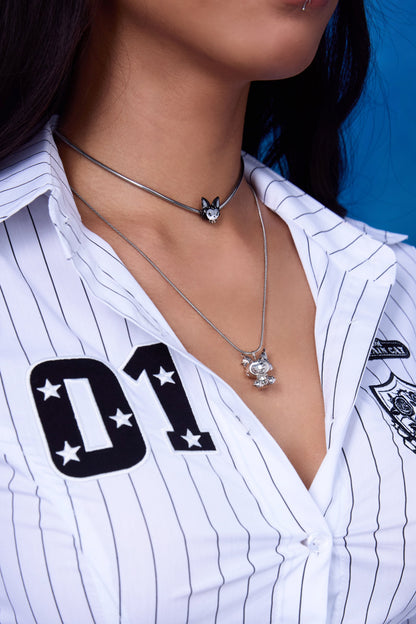 FEFE Dog Drop Necklace and FEFE Dog Choker layered look — silver snake chain with dog figure pendant layered with dog charm choker, styled with white pinstripe shirt
