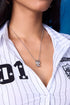 EFE Dog Drop Necklace on model — silver snake chain with gold-plated FEFE dog figure pendant, worn solo at chest level with white pinstripe baseball shirt