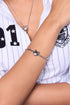 FEFE Dog Bracelet on model — silver snake chain bracelet with FEFE dog face charm, clean wrist shot with white pinstripe baseball shirt